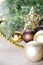 Christmas fir tree branch, golden star, brown balls.