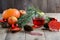 Christmas fir tree branch and herbal tea with toys, pumpkins, apples and autumn leaves