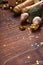 Christmas fir tree branches, champagne, Christmas balls, gift box, golden ribbons and stars on old wooden background for your xmas