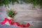 Christmas Firbranch with cones, red polka dot ribbon in the rustic bag on old wooden background