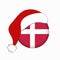 Christmas flag of Denmark in circle shape. Isolated Danish banner with Santa Claus hat.