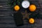 christmas flat lay phone with empty screen on christmas background of green branches and oranges and golden star on black rustic