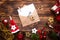 Christmas flat lay on a wooden background with keys to new house in the center with a envelope with a note sheet. New year,