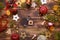 Christmas flat lay on a wooden background with keys to a new house in the center with a place for notes. New year, transfer,