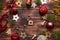 Christmas flat lay on a wooden background with keys to a new house in the center with a place for notes. New year, transfer, share