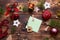 Christmas flat lay on a wooden background with keys to a new house in the center with a place for notes. New year, transfer, share