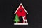 Christmas flatlay layout. wooden toy house, a deer and a Christmas tree on a black glitter shiny background. Christmas card with