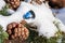 Christmas floral arrangement covered in snow in winter outdoor with snowy silver Christmas ball and fir cone close-up macro