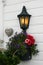 Christmas flower decoration on entry door with a lamp