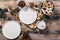 Christmas food flat lay. Empty white plates, dried apples, cinnamon sticks, gingerbread cookies, spruce branches. Wooden planks