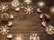 Christmas frame with Christmas ornaments and decorations, snowflakes, angels, snowman, small blue stars, cones on a dark wooden