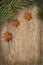 Christmas frame (spruce branches and star anise) on the old wood