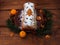 Christmas fruitcake powdered sugar tangerine fir tree festive decoration wooden background flat lay. Stollen cake loaf