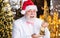 Christmas fun. small and pleasant souvenir. happy man with gold sack gift illuminated background. santa businessman hold