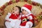 Christmas funny small kids in Santa Claus clothes.