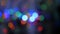 The Christmas garland is flashing with colored lights. Beautiful fuzzy background. Movement of the camera around the