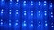 Christmas Garland of Many Blinking, Flickering Blue LED Lights on Curtain. 4K