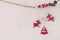 Christmas Garland with red wooden deer, hearts, Christmas-tree and cones.