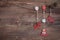 Christmas Garland with red wooden deer, hearts, Christmas-tree and cones. Dark background. Snowflakes.