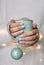 Christmas gift balls in a blue cup in female hands