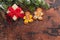 Christmas gift box, gingerbread cookies and fir tree branch covered by snow on wooden background. Top view xmas backdrop with