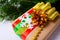 Christmas gift box with golden ribbon, pine cone and beads