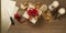 Christmas gift box tied with red and golden bow over a wooden table with candles