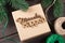 Christmas gift box with wooden lettering miracles happen. Gifts wrapping ideas. Natural design.