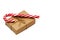 Christmas gift box wrapped in kraft paper tied with twine and candy cane on a white background. Copy space