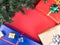 Christmas gift boxes and christmas tree on red background