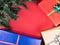 Christmas gift boxes and christmas tree on red background