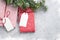 Christmas gift boxes and fir tree branch covered by snow on stone background. Top view xmas backdrop with space for your greetings