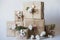 Christmas gift boxes with flowers and decorative objects Eco cotton, cinnamon, spruce branches and jute rope hank over white backg