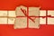 Christmas gift boxes on red background. Burlap canvas wrapping