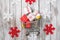 Christmas gift boxes in shopping cart on a wooden background with decorations around, top view. Christmas sale concept.