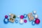 Christmas gift boxes with silver ribbon bow surrounded with Christmas balls. Christmas gifts on a blue background. Pastel colors.