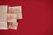 Christmas gift boxes with striped red and white baker's twine paper bag on red background