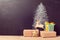 Christmas gift boxes under tree drawing on chalkboard. Alternative Christmas tree background