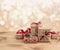 Christmas gift boxes on wooden table over abstract lights background