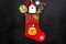 Christmas gift concept, christmas surprises. Traditional festive socks filled with gift box, sweets, winter decor on