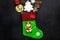 Christmas gift concept, christmas surprises. Traditional festive socks filled with gift box, sweets, winter decor on