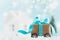 Christmas gift or present box on wheels against turquoise bokeh background. Holiday greeting card.