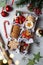 Christmas gift wooden box with homemade cookies and nuts on gray background. Snowflake gingerbread, austrian linzer cookies.