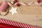 Christmas gift wrapping paper and ribbons supplies on wood background