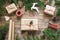 Christmas giftbox and presents wrapping in craft paper and decor on wooden board. Flat lay. Top view.