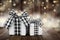 Christmas gifts with black and white buffalo plaid check ribbon against a dark wood and twinkling light background