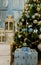 Christmas Gifts And Decorations Near Illuminated Pine Tree With Blue And Silver Glass Balls And Garland Lights