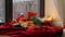 Christmas gifts on red tablecloth on window sill