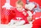 Christmas gifts for toddler. Things to do with toddlers at christmas. Little baby girl play near pile of gift boxes