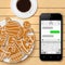 Christmas gingerbread with coffee cup and smartphone with sms chat screen on wooden table